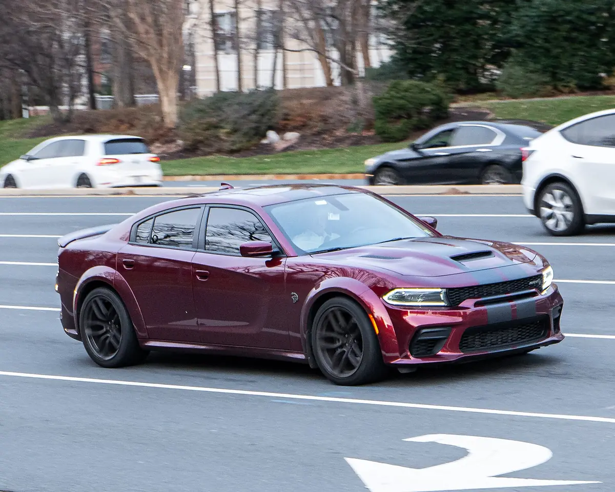 Dark red Dodge Charger SRT Hellcat Widebody on the move, low front three-quarter view