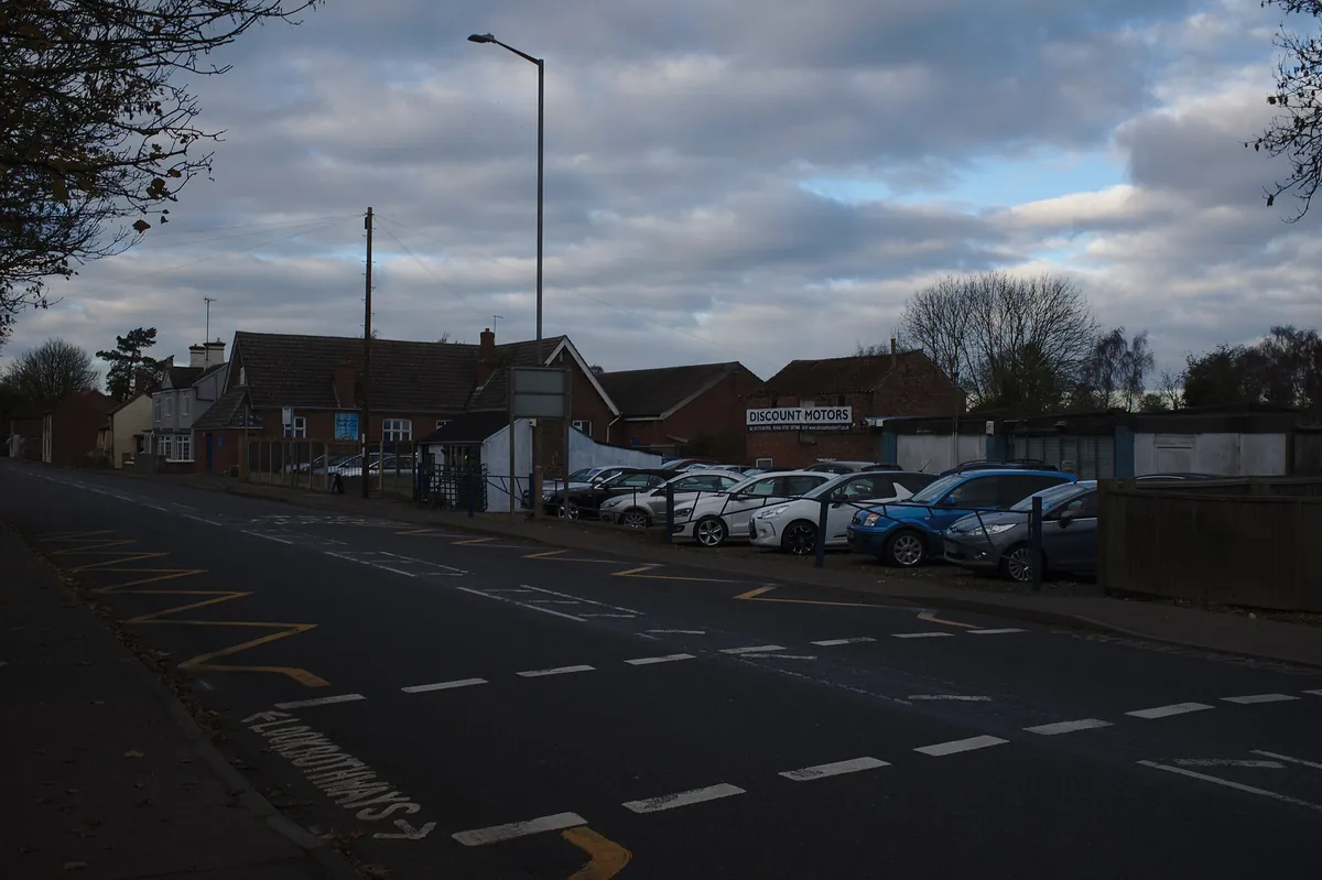 Used cars for sale lined up on a dealer lot